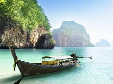 A Thai Longtail boat sits on the shoreline
